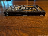 Spine view of the three Moonshot volumes stacked