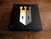Front of closed Reigns board game box
