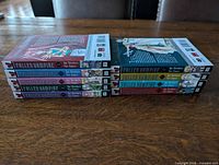 Spines of all nine manga volumes showing sequential numbering 1-9