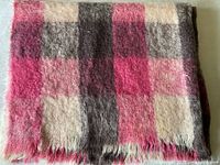 Folded checked mohair blanket showing fringe