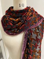 Scarf draped on mannequin showing front view and pattern