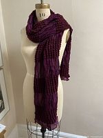 Full view of burgundy silk scarf draped on mannequin