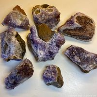 Eight irregular amethyst rock pieces laid out