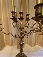 close-up of scrolling arms and candle sockets