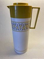 Full view of cream thermos with mustard lid and handle