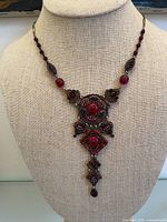 Full view of necklace on bust showing chain and pendant