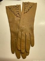 Full view of the pair of caramel kid leather gloves