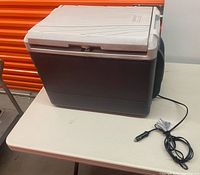 Cooler exterior with lid closed and 12-V cord visible