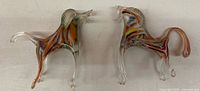 Front view of both glass horse figurines