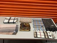 Overview of all seven scarves laid on table