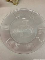 Clear frosted glass plate with etched bird design and handprints