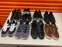 All eight shoe pairs lined on table