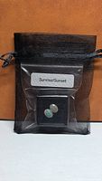 Pair of opals in mesh drawstring pouch labelled Sunrise/Sunset