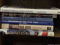 Stack of six military history books on shelf