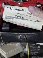 Bore sighter inside case with instruction leaflet visible