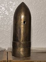 Full view of brass projectile-shaped trench art shell