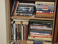 Full view of two shelves filled with military, railroad and travel books