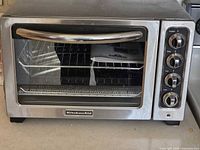 Front view of KitchenAid toaster oven showing glass door and handle