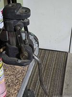 Overall side view of Hollywood cast iron reloading press bolted to bench