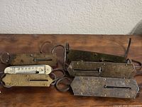 Group of five vintage hanging spring scales on table