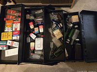 Overall view of four-section case filled with tins and bottles