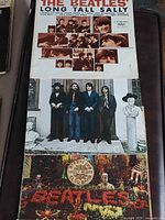 Cover art for three Beatles LPs stacked: Long Tall Sally, Hey Jude, Sgt. Pepper’s.