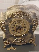 Front view of ornate New Haven mantel clock showing dial, case details, and dimensions perspective