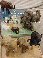 Group shot of all elephant figurines arranged on elephant photo book