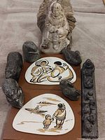 Group shot showing all carvings and two prints