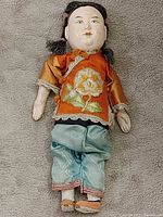 Full view of Chinese opera doll lying flat