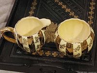 Creamer and sugar bowl together on tray, showing matching design