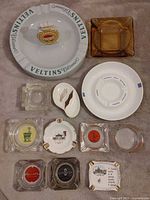 Group shot of all twelve ashtrays showing variety of materials, shapes and logos