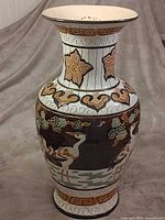 Full view of tall ceramic vase with crane scene