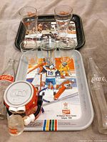 Group shot showing trays, glasses, bottles, coin bank