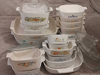 Entire group of Corning Ware dishes and Pyrex lids stacked