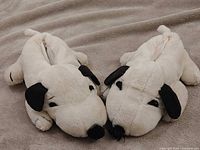 Both Snoopy plush slippers side by side showing overall design, color and condition