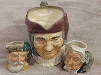 Front view of three Royal Doulton character jugs