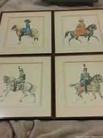 All four framed lithographs displayed together