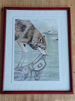 Framed Sue Coleman wolf print with red frame and white mat