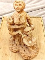Full view of terracotta sculpture on wooden surface