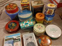 Group shot of assorted tins in lot