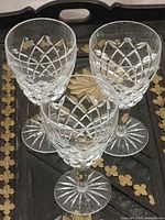 Three Waterford Comeragh sherry glasses showing cut pattern and height