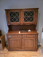 Full view of buffet and hutch showing upper glass cabinet and lower storage