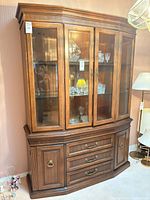 Front view of buffet hutch showing glass doors, drawers, cabinets