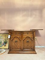 Front view of oak buffet sideboard showing drawers, doors, hardware, slide-out extensions