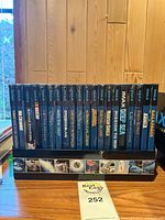 Row of IMAX DVDs in display box showing titles on spines