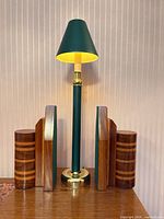 Lamp with shade illuminated, four wooden candle holders arranged around base