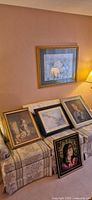 All five artworks displayed on and above sofa