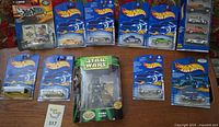 All packaged Hot Wheels cars and Star Wars Boba Fett figure displayed together
