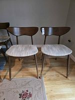 Front view of both chairs showing design and upholstery